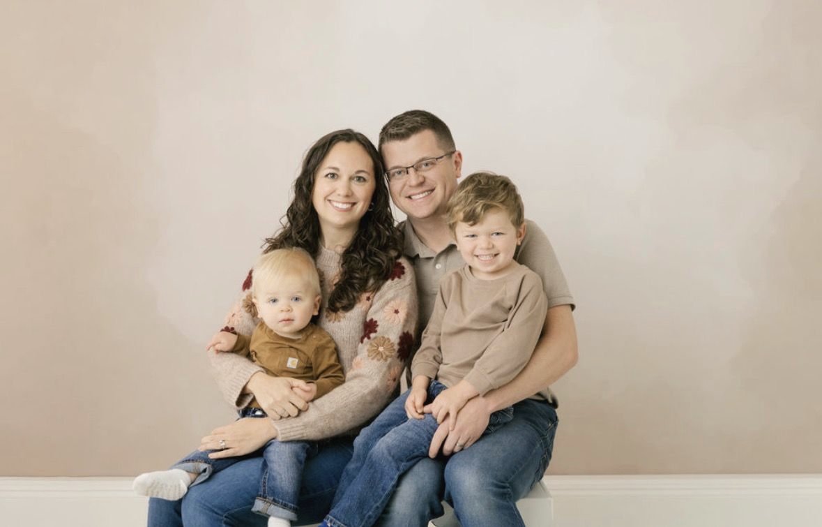 Alex and Lauren with their two sons in a studio family portrait