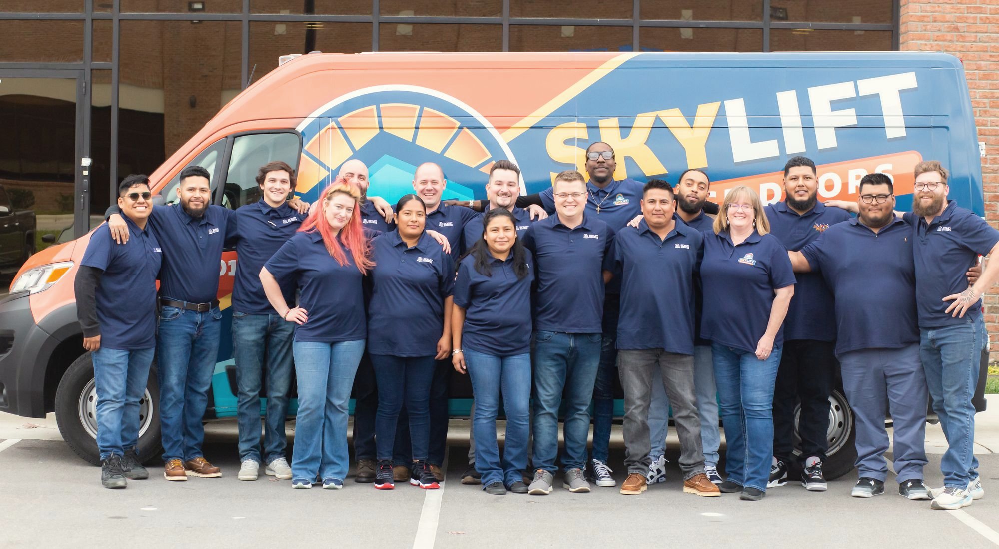 The Skylift Garage Doors team standing in front of a Skylift van